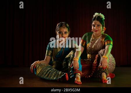 Bharatnatyam dancer performing with her young student. Stock Photo