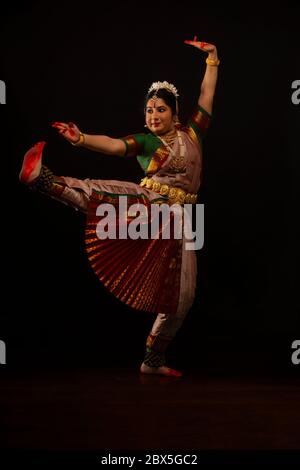 Bharatnatyam dancer doing ek  padam during her performance. Stock Photo