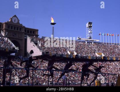 General view of the Olympic Games, Barcelona 1992 showing mens hurdles with the Montjuic Stadium and Olympic flame in the background. Photo by Tony Henshaw    No commercial use. Editorial only. Stock Photo