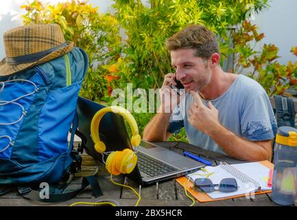 young attractive and happy digital nomad man working outdoors with laptop computer cheerful and confident running business remote in freelancer and in Stock Photo
