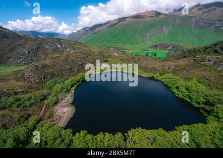 The dark surface of Diamond Lake in Wanaka, New Zealand Stock Photo