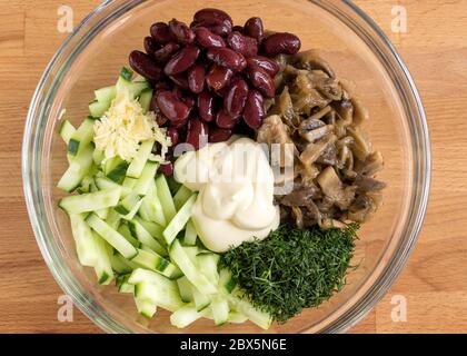 Different salad ingredients in one bowl. Mayonnaise salad, top view. Stock Photo