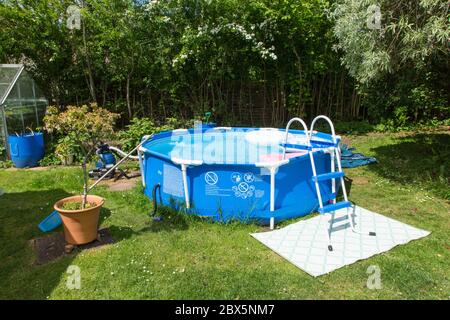 Summer steel framed above ground swimming pool, Medstead, Alton, Hampshire. Stock Photo