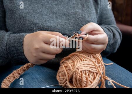 Women's hands knit from color wool. Hand knitting Stock Photo
