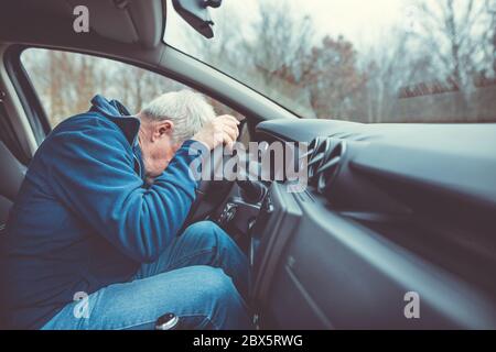 Man driving car and falling asleep at the wheel, transportation concept Stock Photo