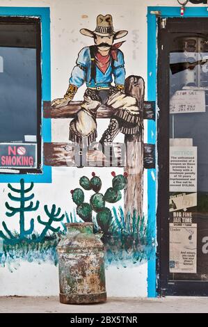 Western art wall paintings at storefront of roadside store and cafe Contreras on highway US-59 near Laredo, Texas, USA Stock Photo