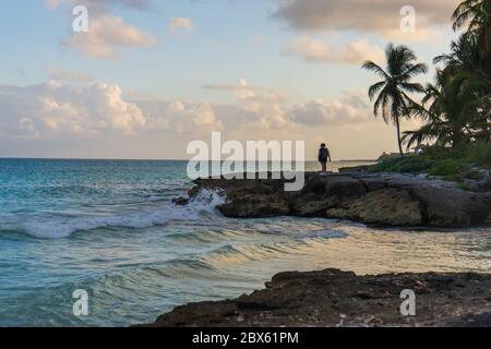 beautiful evening on the rocky shores of the Caribbean Sea in Tulum, Mexico Stock Photo