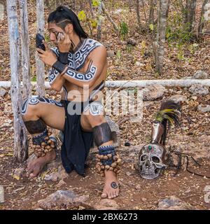 Valladolid, Yucatan/Mexico - February 24,2020: young Mayan men preparing themselves in costume for performing traditional Mayan ceremony Stock Photo