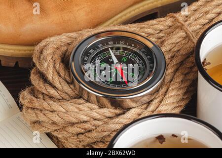 Compass surrounded by mountain gear tools on wooden background Stock Photo