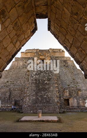 looking through a stone arch at the Mayan ruins in Uxmal Stock Photo