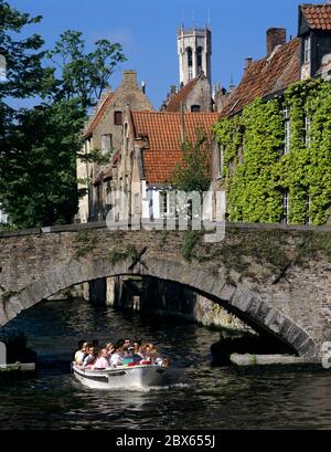 Tour boat travelling along canal in the old town Stock Photo