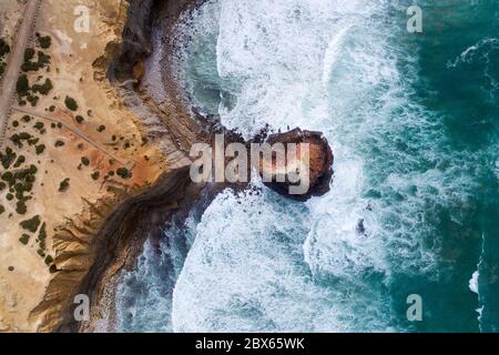 Aerial drone photo of the waves crashing against the rocks in the beautiful coastline along the Vicentine Coast, near the Bordeira Beach, in Algarve, Stock Photo