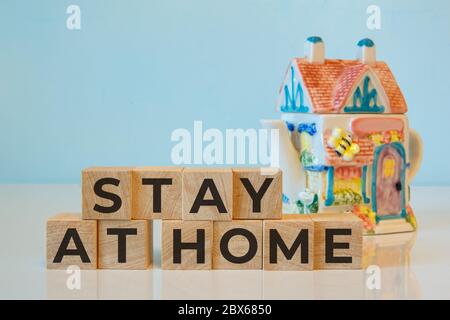 STAY AT HOME words written on wooden cubes. Concept home quarantine Stock Photo