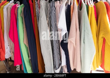 Collection of clothes hanging on rack Stock Photo