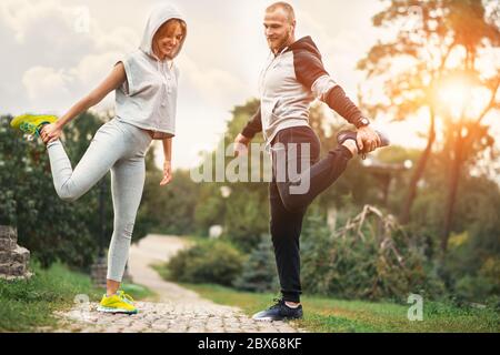 Urban sports - couple jogging for fitness in the city with beautiful nature. Stock Photo