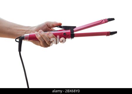 Hand holding curling iron isolated on white background. with clipping path. Stock Photo