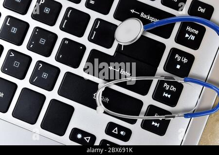 Stethoscope medical on a laptop keyboard. Healthcare and medicine or antivirus protection concept Stock Photo