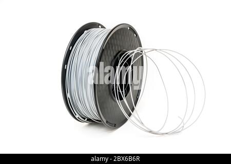 3D Printer Plastic Filament. Spool of grey thermoplastic wire for 3D printing close up isolated on white background Stock Photo