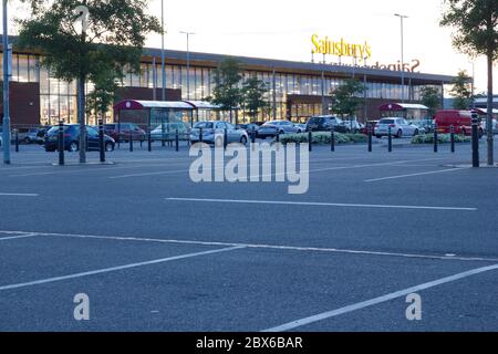 Car park outside Sainsbury's supermarket almost empty lack of shopper due to covid-19 pandemic in England, UK Stock Photo