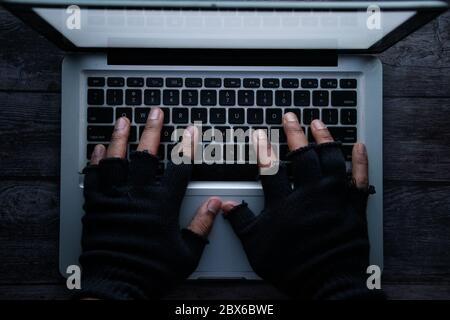 high angle view of hacker stealing data from laptop  Stock Photo