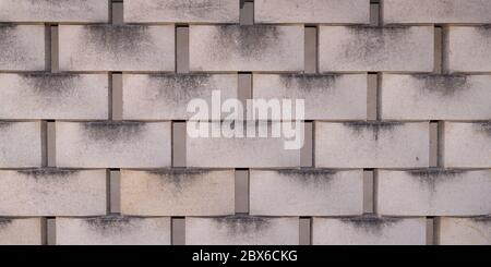 Concrete tile cinder block wall cladding texture grey background Stock Photo