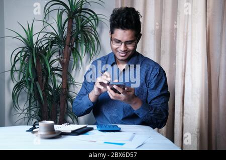 happy asian businessman using smart phone at office  Stock Photo