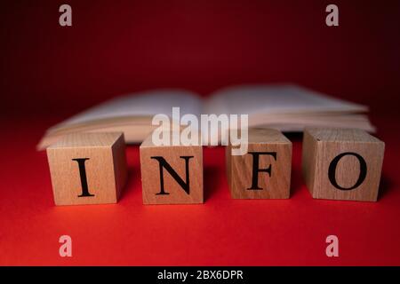 It writes the words info, success, work on the cubes on the wooden table. Stock Photo