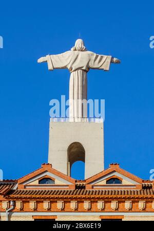 Sculpture of Jesus Christ from the back with roof elements of the Reception Building of National Sanctuary of Christ the King. Stock Photo