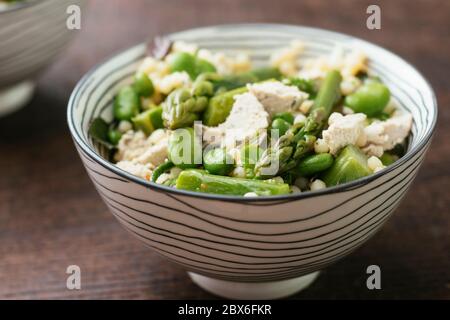 Bowl with a home made Asparagus, Fava Bean Salad with Mint and Vegan Feta.