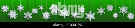 Christmas banner of large white complex paper hanging snowflakes on green background Stock Vector