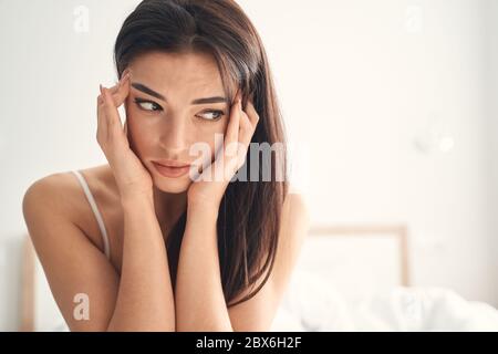 Young woman suffering from headache in the morning Stock Photo