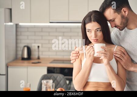 Helpful man supporting his beloved woman in difficult situation Stock Photo