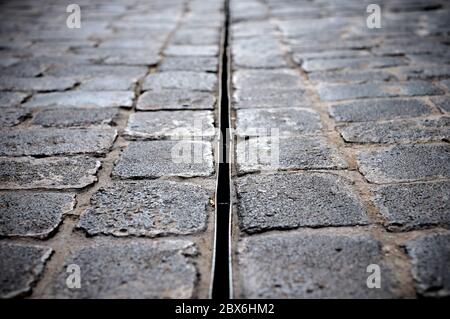 Close low view of a paved street, selective focus and a slight vignette. Stock Photo