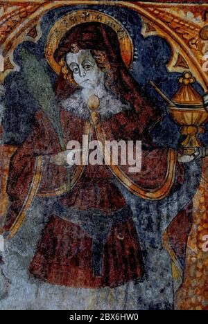 Early Christian martyr and Arab doctor of medicine, Saint Cosmas, whose name appears in Glagolitic script in his halo.  Renaissance fresco by 1400s German artist, Albert of Konstanz, in Church of the Blessed Virgin and Saint George the Younger at Plomin, Istria, Croatia.  Cosmas and his brother, Damian, were skilled physicians who practised in the Mediterranean port city of Aegeae, then in Roman Syria and now in modern Turkey’s Adana province.  They were arrested, tortured and executed during the persecution of Christians by Roman Emperor Diocletian. Stock Photo