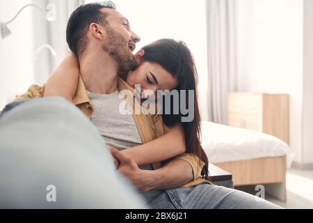 Attractive just married couple hugging at home Stock Photo