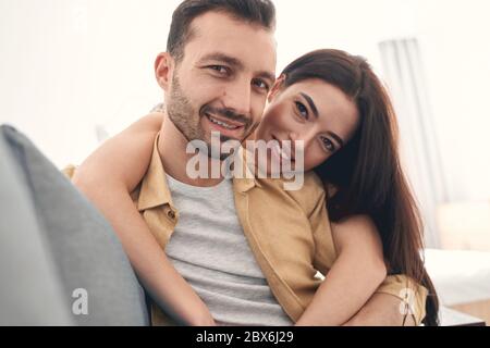Smiling young man and woman embracing happily with love Stock Photo
