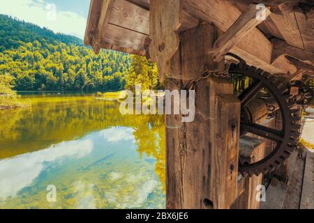 View of an ancient wooden watergate at the legendary Lake Toplitz, Ausseer Land region, Styria, Austria, regulating the waterflow of the Toplitz river Stock Photo