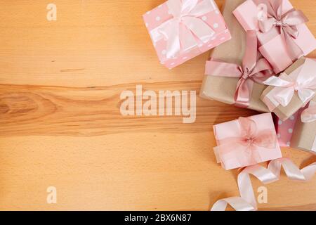 Set of beautiful gift boxes with pink bows on a wooden table. Stock Photo