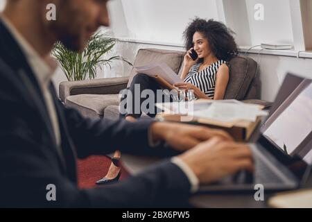 Pleased young lady talking on the phone Stock Photo