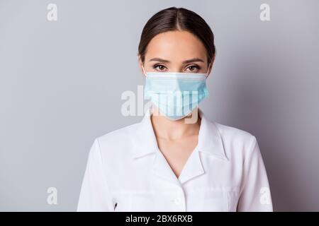 Closeup photo of attractive serious virologist doc lady experienced professional listen patient wear facial cotton mask medical uniform lab coat Stock Photo