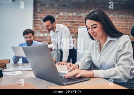 Happy teammates working on startup project in modern office Stock Photo