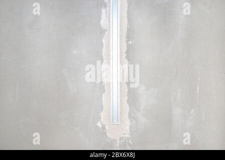 Aluminum profile for LED lighting placed in the ceiling in a newly built house. Stock Photo