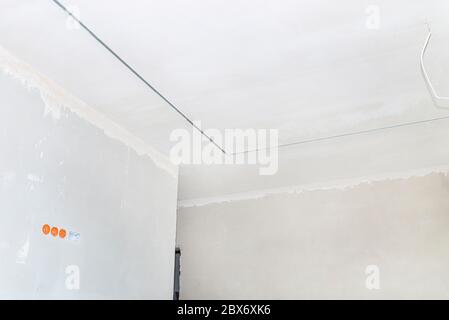 Aluminum profile for LED lighting placed in the ceiling in a newly built house. Stock Photo