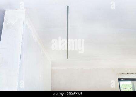 Aluminum profile for LED lighting placed in the ceiling in a newly built house. Stock Photo