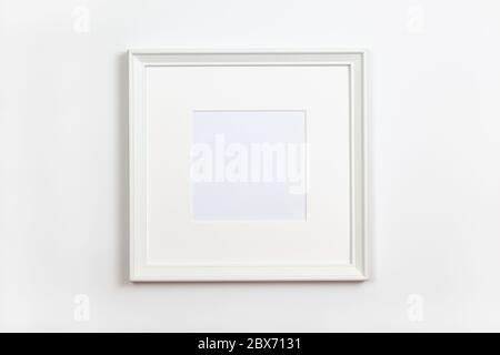 White clean square frame with passepartout on white background, copy space. Flat lay or side view, minimal style mock-up. For gift shop, social media, Stock Photo