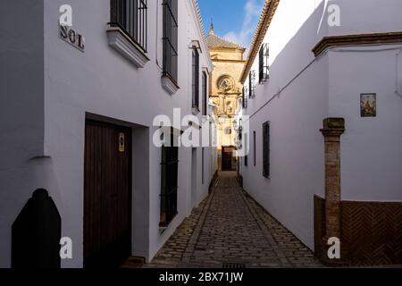 The narrow streets of the medieval city with the bell tower in the background. Carmona, Andalusia. Spain Stock Photo