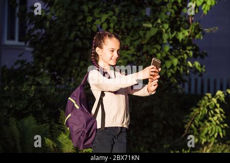 Child is making a selfie at sunset Stock Photo