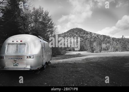 Maine USA -October 6 2014; American iconic travel trailer parked in great outdoors monochrome with spot color. Stock Photo
