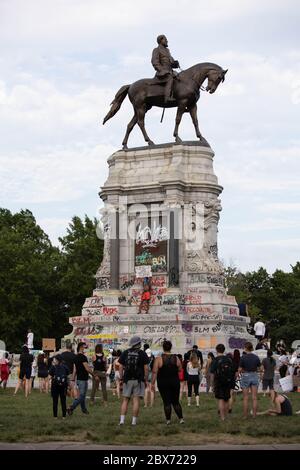 Protests at the statue of Confederate General Robert E. Lee in Richmond with graffiti covering the marble base. Racial injustice and police brutality. Stock Photo