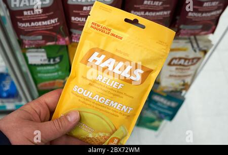 Montreal, Canada - May 03, 2020: Halls Mentho Lyptus drops pack in a hand. Halls is the brand name of a popular mentholated cough drop. Halls cough dr Stock Photo